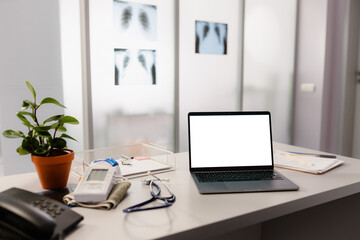 A laptop with a white screen on the doctor's desk