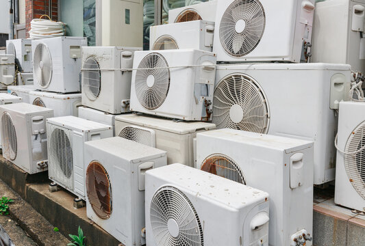 There are a lot of broken air conditioners piled up.