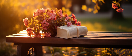 Bible on Bench with Pink Flowers in Sunlight