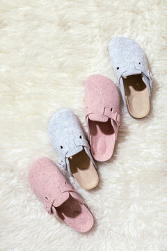 Female slippers on a faux rug