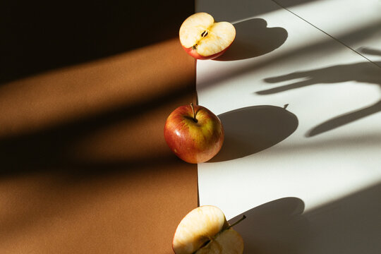 Apples with a hand shadow grabbing