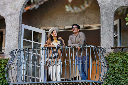 Couple relaxing on balcony of hotel room