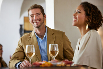 Couple wine tasting at winery laughing