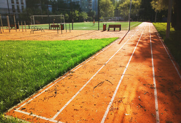 Empty running track during sunset time sport background
