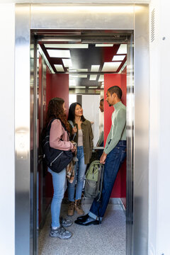 Coworker friends inside elevator
