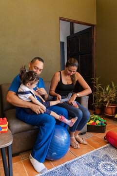 Mother practicing how to help daughter wear leg braces