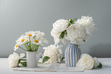 Ceramic vases with white peonies and daisies. Summer mood. Greeting card, copy space.