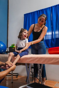Experienced physiotherapist doing foot massage to client in clinic