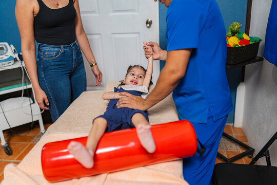 Little girl at physical therapy session in health clinic