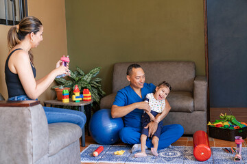 Man physiatrist with girl and observing mother