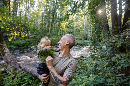 Father tickles child with a horsetail