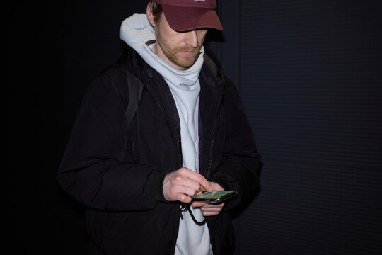 Man texting on smartphone at night