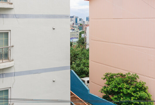 City view seen between the building walls.