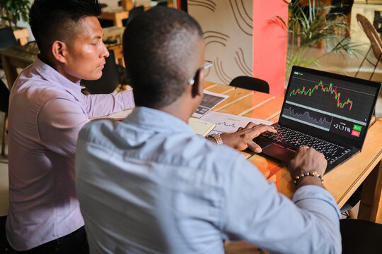 Two Latino men trading