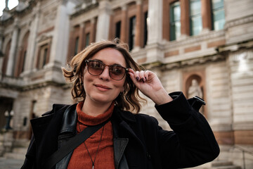 Happy tourist woman in front of historical building in London.