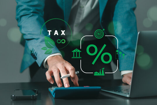 Environmental tax breaks concept. Businessman touching green taxes icons.Using environmental taxes, carbon tax, environmentally beneficial tax incentives in order to achieve environmental targets.