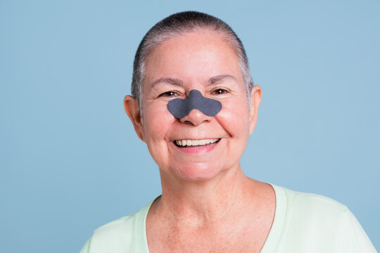 Horizontal portrait of a senior Woman With Pore Strip On Nose