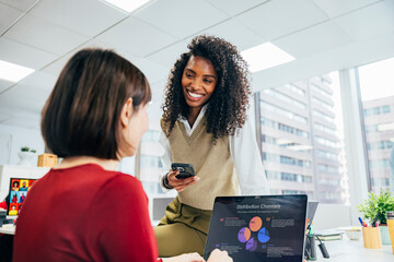 Colleagues interacting at a modern office workspace