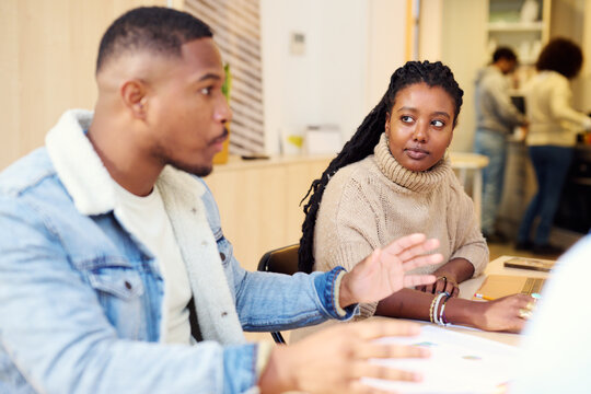 Engaged Team Members in Office Brainstorming Session