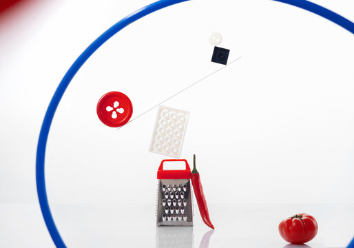 Abstract composition made of colorful constructor, grater, red button