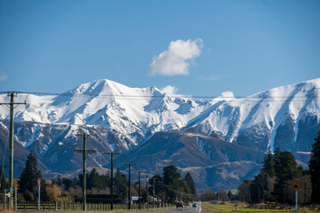 A road leading to snow covered mountains