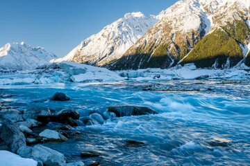 Tasman River flow with snowcapped mountains and icebergs