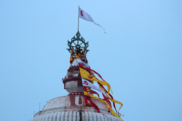 Sudarshana Chakra is an attribute of Vishnu on the dome of the Jagannath Temple in Puri at dusk.