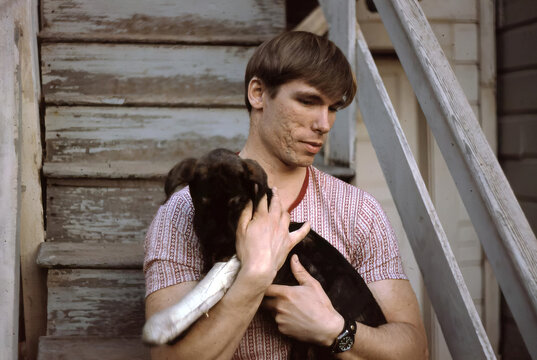 Vintage photo of young man with pup