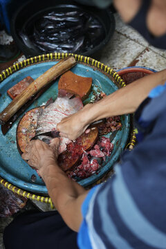 Preparing Fish in a Traditional Market Setting