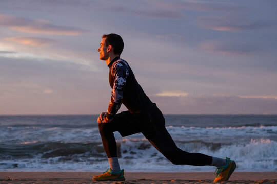 Straching before morning run on the beach.