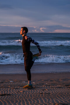 Straching before morning run on the beach.