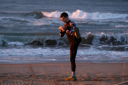 Straching before morning run on the beach.