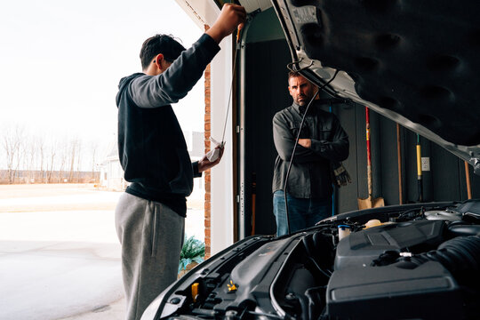 Checking the oil on a car. 