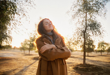 A woman in a coat in a morning light