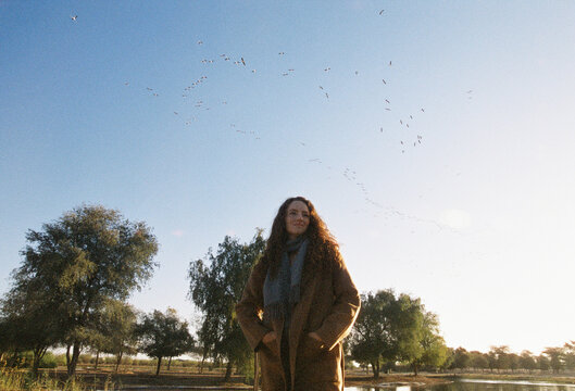 A woman in the nature by the lake