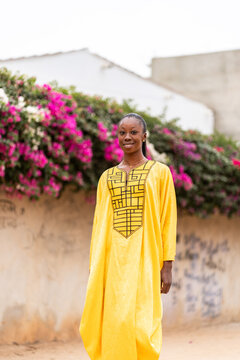 Woman in Yellow Dress Standing Among Flowers