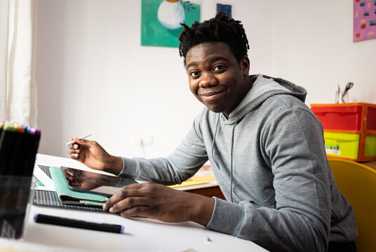 Smiling teenager at drafting desk