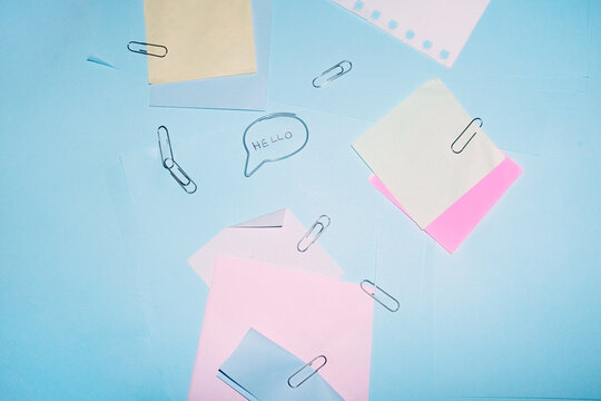 Colourful office supply and speech bubble paper clip saying hello