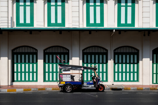 Tuk tuk traveling on the street in the midday sun