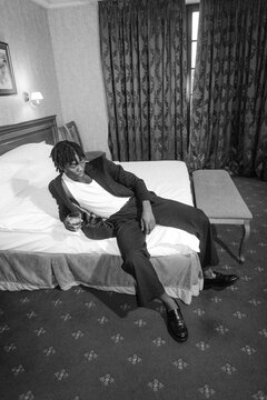 A man drinks alcohol indoors