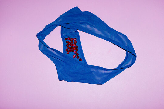 Contemporary photo of underpants and red pearl blood with flashlight