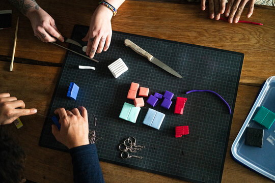 Three pairs of hands crafting