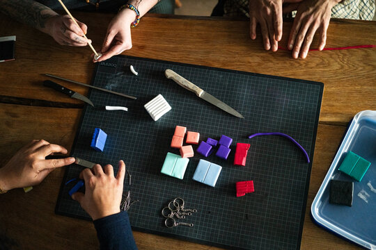 Three pairs of hands crafting