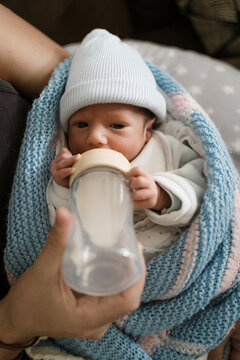 A premature baby drinks formula milk from a bottle