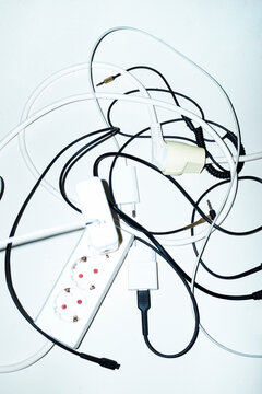Wires, chargers and cords on a business office floor with flashlight