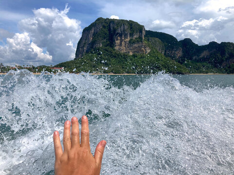 hand touching sea splashes 