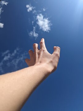 UGC hand against sky