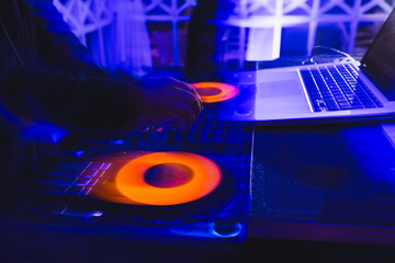 Vibrant DJ session with colorful lighting at nightclub