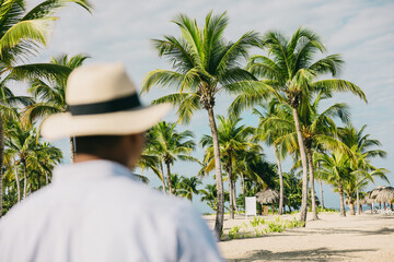 Man enjoying tropical beach view with palm trees