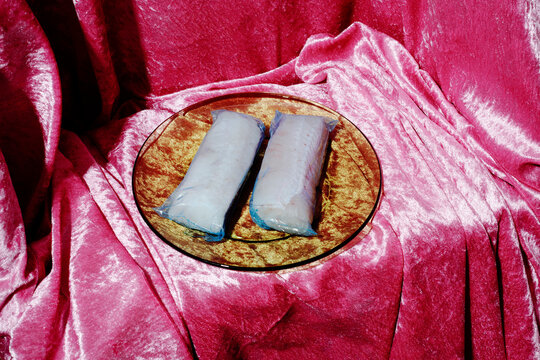 glass plate with a pair of frozen hake loins